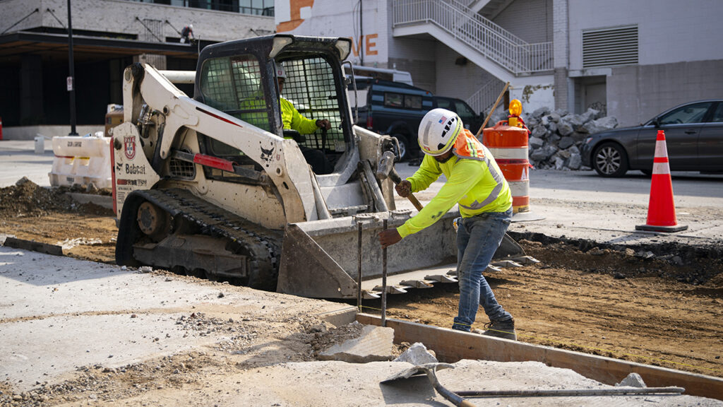 A construction worker hammers a beam while renovating a road in the Union Market district in Washington, DC, US, on Friday, Sept. 8, 2023. US employment
